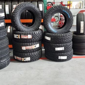 All-terrain tires stacked on the shop rack