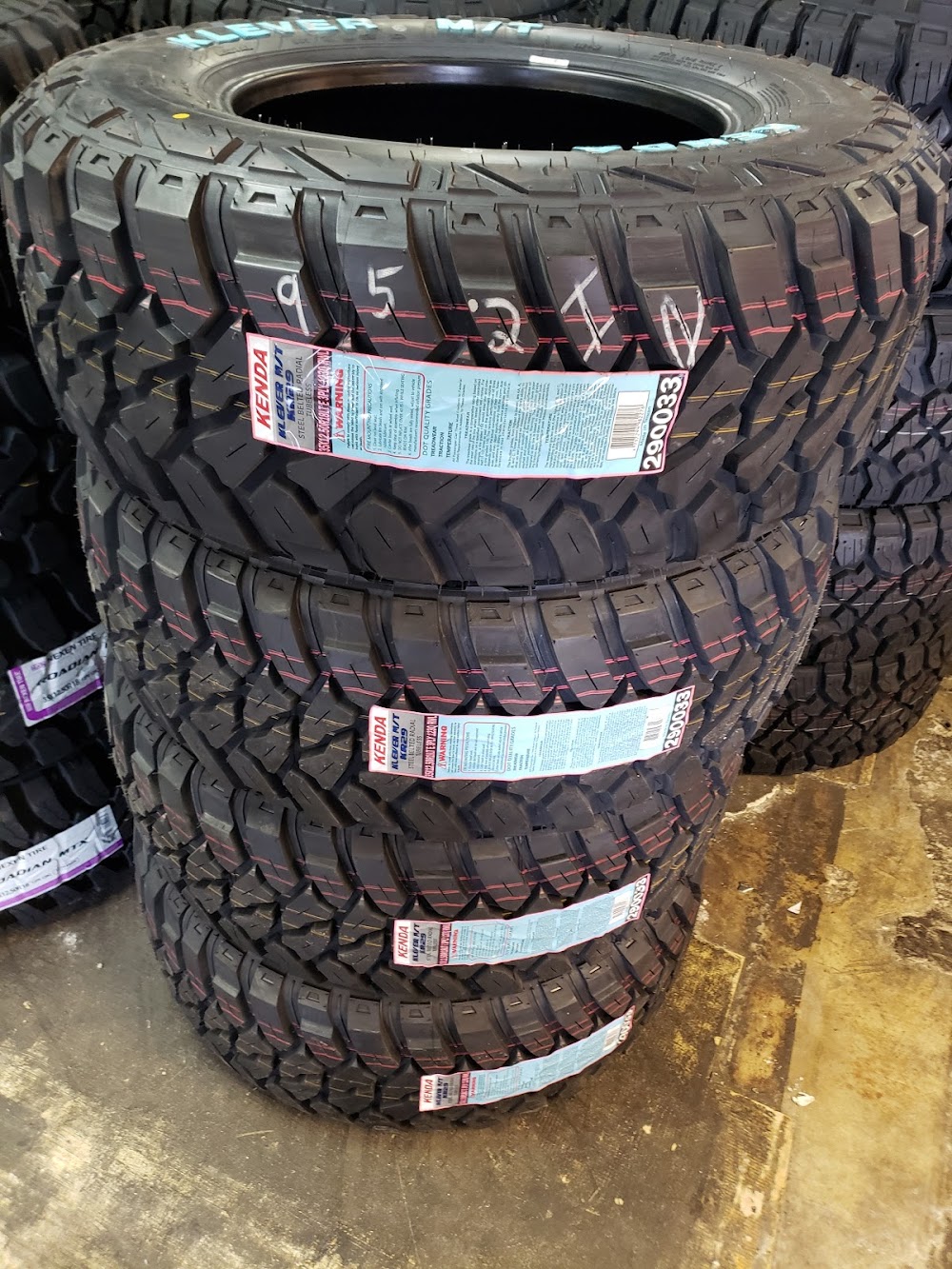 Kenda Klever mud-terrain tires stacked in the shop